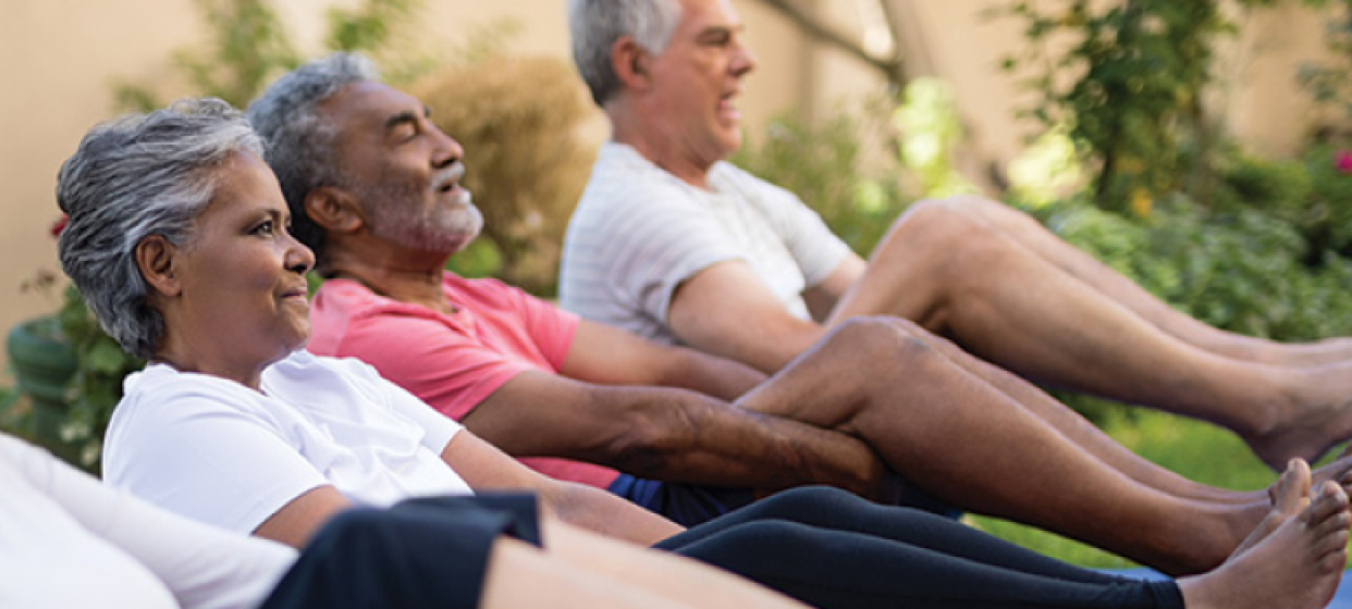 A picture of a group of people exercising together.