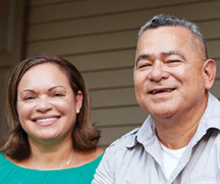 A picture of a man and a woman with smiling faces posing for a photo.