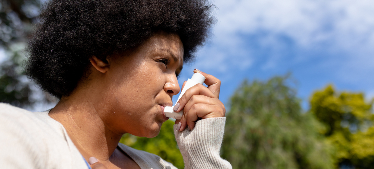 Woman using an inhaler