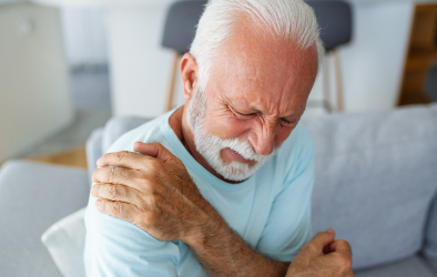 Elderly man experiencing shoulder pain.