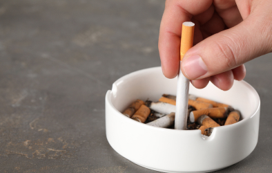 A cigarette stubbed out in an ashtray.
