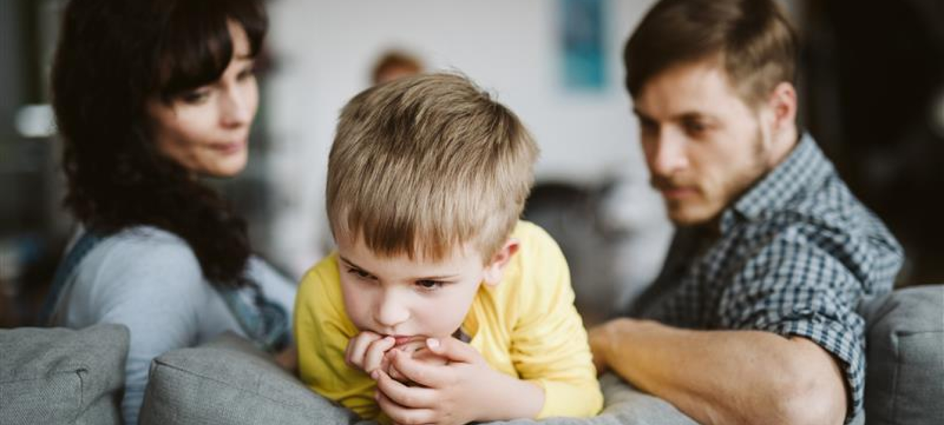 Child thinking while parents watch.